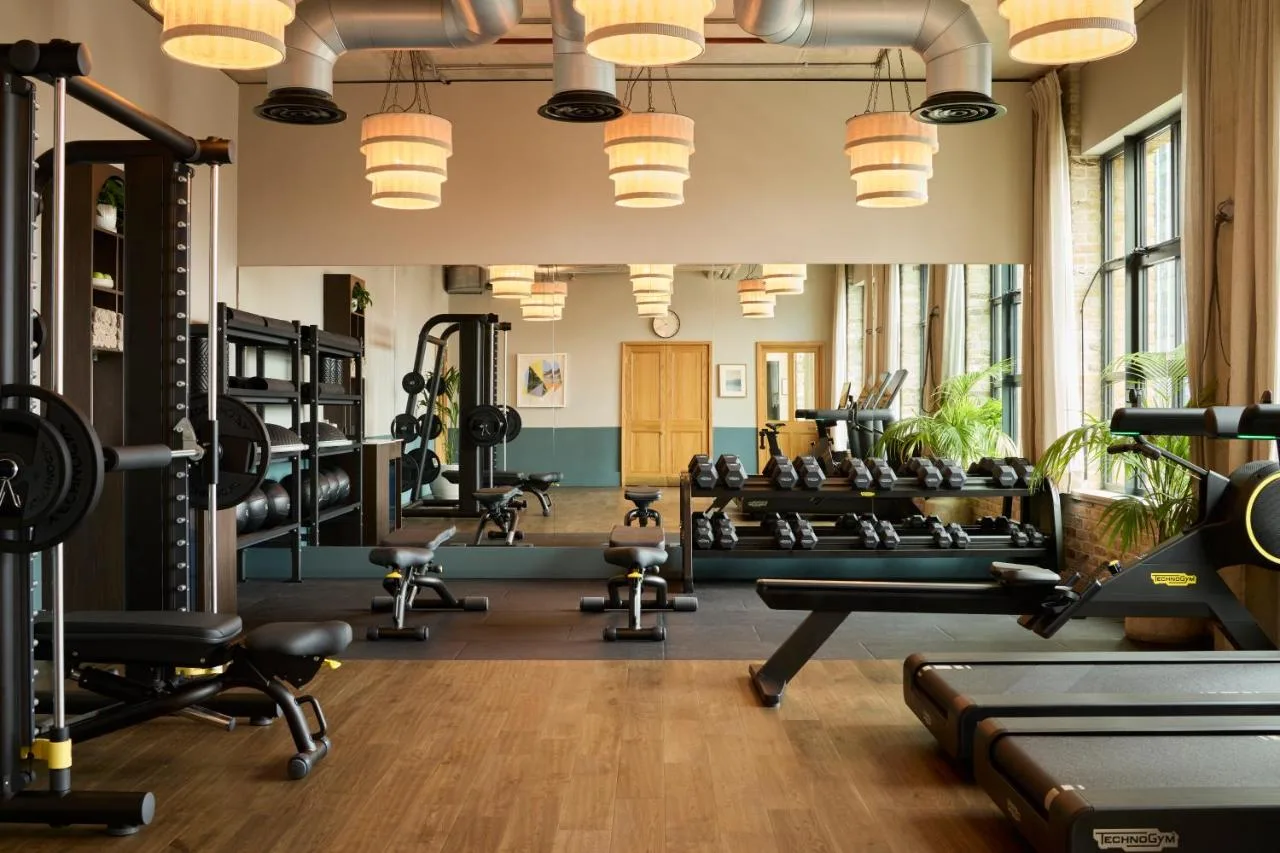 a gym with lots of treadmills and weights at The Hoxton, Southwark in London