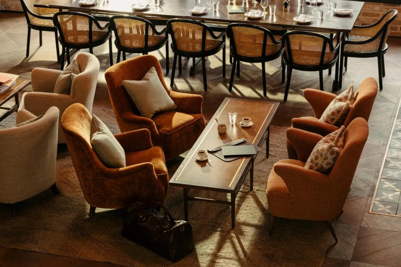 a group of chairs and tables in a restaurant at The Hoxton, Southwark in London