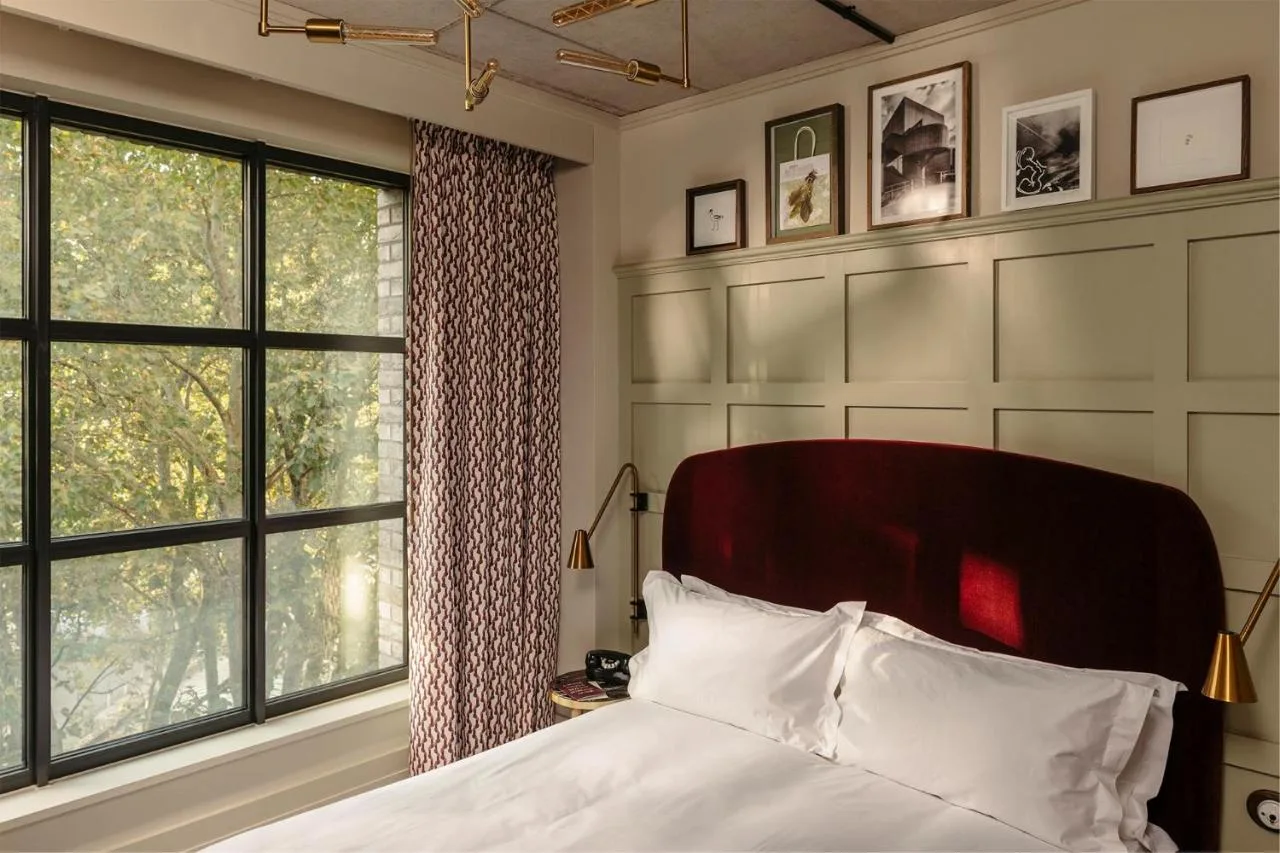 a bedroom with a bed and a large window at The Hoxton, Southwark in London